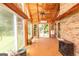 Bright sunroom with wood ceilings, a tile floor, and many large windows overlooking the backyard at 1502 Campground, Mcdonough, GA 30252