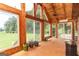 Bright sunroom with wood ceilings, a tile floor, and many large windows overlooking the backyard at 1502 Campground, Mcdonough, GA 30252