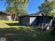 Backyard with a storage shed, mature trees, and lush grass at 266 Ridge Trl, Riverdale, GA 30274