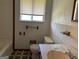 This bathroom features a toilet, a shower-tub combo, and small vanity at 266 Ridge Trl, Riverdale, GA 30274