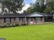 Charming brick home with a well-maintained lawn and beautiful hydrangea bushes at 266 Ridge Trl, Riverdale, GA 30274