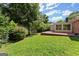 Green backyard showing patio, sunroom, lawn, landscaping and a storage shed at 2826 Summit Ridge Dr, Marietta, GA 30066