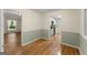 Dining room featuring hardwood floors, wainscoting, and a view into kitchen and living room at 2826 Summit Ridge Dr, Marietta, GA 30066