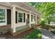 Inviting front porch with black shutters, brick accents and 'Welcome' sign at 2826 Summit Ridge Dr, Marietta, GA 30066
