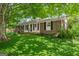 Charming brick home with a well-manicured lawn surrounded by lush greenery at 2826 Summit Ridge Dr, Marietta, GA 30066
