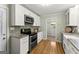 Updated kitchen features stainless appliances, granite counters, and white cabinets at 2826 Summit Ridge Dr, Marietta, GA 30066