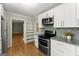 Updated kitchen boasting stainless steel appliances, granite countertops, and stylish backsplash at 2826 Summit Ridge Dr, Marietta, GA 30066