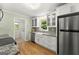 Well-lit kitchen features a farmhouse sink, modern appliances, and a view to the laundry area at 2826 Summit Ridge Dr, Marietta, GA 30066