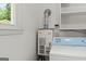 Laundry room area with shelving, a view of the exterior, and a Paloma water heater at 2826 Summit Ridge Dr, Marietta, GA 30066