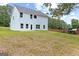 This home features a large backyard with a grass lawn and light blue siding at 5341 Stewart Mill Rd, Douglasville, GA 30135