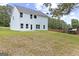 A spacious backyard with a freshly painted light blue home, with ample space for outdoor activities at 5341 Stewart Mill Rd, Douglasville, GA 30135