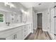 Bright bathroom with a double vanity, quartz countertop, and a glass-enclosed shower at 5341 Stewart Mill Rd, Douglasville, GA 30135
