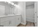 Bright bathroom with a double vanity, quartz countertop, and a tub-shower combo at 5341 Stewart Mill Rd, Douglasville, GA 30135