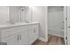 Bright bathroom featuring a double vanity, a large mirror, and a shower-tub combination at 5341 Stewart Mill Rd, Douglasville, GA 30135
