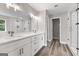 Bright bathroom featuring double vanity, a large mirror, and a glass-enclosed shower at 5341 Stewart Mill Rd, Douglasville, GA 30135