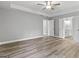 Spacious bedroom with hardwood floors, neutral walls, and an ensuite bathroom at 5341 Stewart Mill Rd, Douglasville, GA 30135