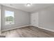 A simple, unfinished bedroom with neutral paint, baseboard trim, plank floors, and a closet at 5341 Stewart Mill Rd, Douglasville, GA 30135