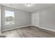 Simple bedroom with wood-look floors, natural light and a built-in closet at 5341 Stewart Mill Rd, Douglasville, GA 30135