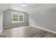 Empty bedroom with a vaulted ceiling, wood-style flooring, and a large window at 5341 Stewart Mill Rd, Douglasville, GA 30135