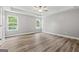 Spacious bedroom with hardwood flooring, ample natural light from windows, and a ceiling fan at 5341 Stewart Mill Rd, Douglasville, GA 30135