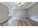 Large bedroom featuring neutral walls, hardwood floors, and natural lighting at 5341 Stewart Mill Rd, Douglasville, GA 30135
