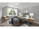 This bedroom boasts a large window, neutral paint, and stylish furnishings for a serene retreat at 5341 Stewart Mill Rd, Douglasville, GA 30135