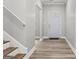 Inviting entryway with wood stairs, white walls, and a clear view of the front door at 5341 Stewart Mill Rd, Douglasville, GA 30135