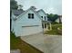 Charming two-story home with light blue siding, white trim, and a spacious driveway at 5341 Stewart Mill Rd, Douglasville, GA 30135