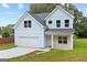 Charming two-story home with light blue siding, a garage, and a well-manicured lawn at 5341 Stewart Mill Rd, Douglasville, GA 30135