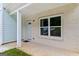 Inviting front porch featuring white painted brick, a covered porch, and an entry door at 5341 Stewart Mill Rd, Douglasville, GA 30135