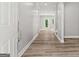 Bright hallway with modern wood-look flooring and white trim throughout the home at 5341 Stewart Mill Rd, Douglasville, GA 30135
