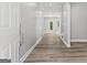 Modern hallway with wood-look flooring, neutral walls, and plenty of natural light at 5341 Stewart Mill Rd, Douglasville, GA 30135