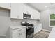 Well-lit kitchen showcasing white cabinets, stainless steel appliances, and quartz countertops at 5341 Stewart Mill Rd, Douglasville, GA 30135