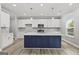 Modern kitchen with white cabinets, a navy island, and stainless steel appliances at 5341 Stewart Mill Rd, Douglasville, GA 30135