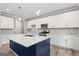 Elegant kitchen with white cabinets, a blue island, a stainless steel range, and pendant lighting at 5341 Stewart Mill Rd, Douglasville, GA 30135