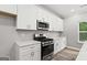 Modern kitchen features stainless steel appliances, white cabinets, and bright countertops at 5341 Stewart Mill Rd, Douglasville, GA 30135
