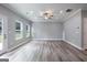 Bright living room with hardwood flooring, windows, and a glass door to the outside at 5341 Stewart Mill Rd, Douglasville, GA 30135