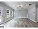 Open living room space with hardwood flooring and an outside view from the windows and door at 5341 Stewart Mill Rd, Douglasville, GA 30135