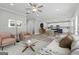 Open-concept living room featuring neutral tones, a ceiling fan, and seamlessly connected kitchen at 5341 Stewart Mill Rd, Douglasville, GA 30135