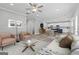 Open-concept living room with neutral tones, modern furnishings, and a view into the kitchen at 5341 Stewart Mill Rd, Douglasville, GA 30135