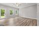 Bright living room with hardwood flooring, windows, and a glass door to the outside at 5341 Stewart Mill Rd, Douglasville, GA 30135