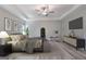 This main bedroom is staged with decor and a ceiling fan and features a large bed and a full-length mirror at 5341 Stewart Mill Rd, Douglasville, GA 30135