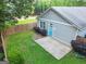 Aerial view of the backyard features a concrete patio and beautiful green lawn, perfect for outdoor activities at 1283 Mercer, East Point, GA 30344