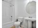Bathroom featuring a tub and shower combination, white toilet and pedestal sink at 1283 Mercer, East Point, GA 30344