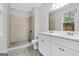 A bathroom featuring a double sink vanity, granite counters, and tiled shower at 1283 Mercer, East Point, GA 30344