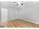 A bright bedroom with wood-look flooring, neutral walls, ceiling fan and bathroom entrance at 1283 Mercer, East Point, GA 30344
