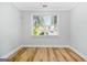 Bedroom featuring wood-look flooring, neutral walls, and a large window at 1283 Mercer, East Point, GA 30344