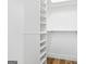 A walk-in closet with white shelving and wood-look flooring at 1283 Mercer, East Point, GA 30344