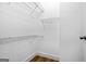 A walk-in closet with white wire shelving and wood-look flooring at 1283 Mercer, East Point, GA 30344