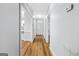 Hallway view with wood flooring and views into the kitchen and to the front door entrance at 1283 Mercer, East Point, GA 30344